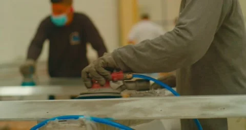 Operators of a metal processing factory polishing metal parts. Video stock 239038930