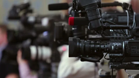 Operators work with equipment in row of few cameras Stock Footage 28505677