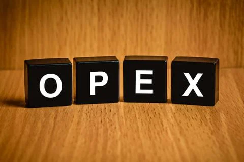 OPEX or Operating expense word on black block Stock Photos