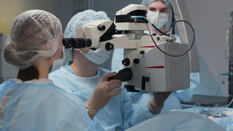 Ophthalmic Surgery Team Operating Microscope during Eye Procedure Stock Footage 310247081