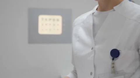 Ophthalmologist examines the document without the doctor's face Stock-Footage 97519107