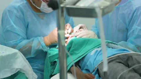 Ophthalmologist operating on a child patient with another doctor assisting him Stock Footage 77448006