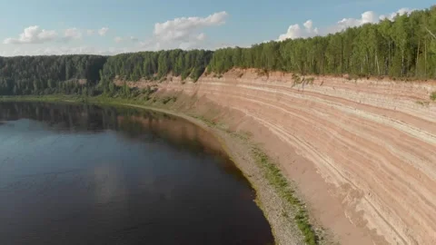Opoki. Aerial view shows a calm river beside a steep red clay cliff Stock Footage 336747485