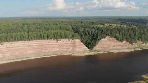 Opoki. Aerial view of a winding river beside a forested cliff Stock Footage 335965413
