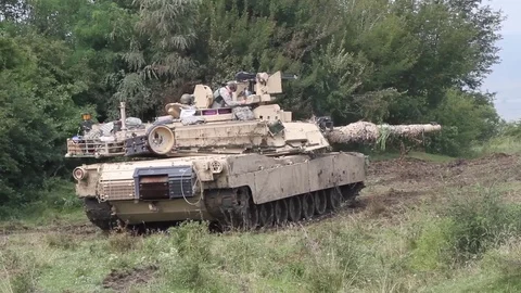 Opposing forces camouflaging M1A1 to blend in with terrain - 2016 Stock Footage 92751093
