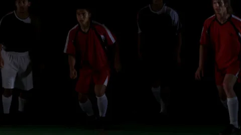 Opposing teams compete against each other to head the ball. Medium shot. Stock Footage 34442676