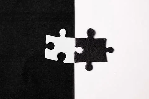 Opposite day concept using white and black puzzle pieces with oposite background Stock Photos