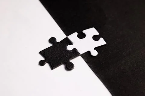 Opposite day concept using white and black puzzle pieces with oposite background Stock Photos