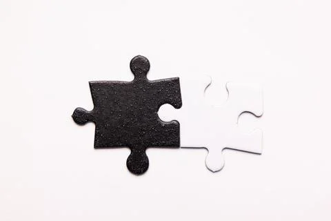 Opposite day concept using white and black puzzle pieces. Stock Photos