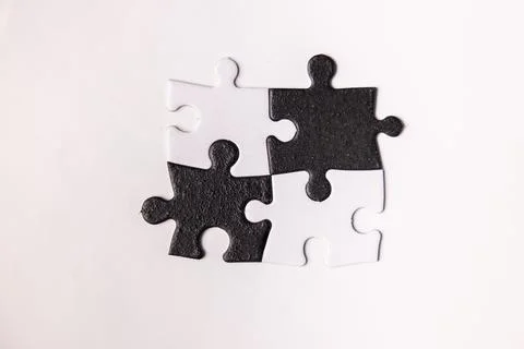 Opposite day concept using white and black puzzle pieces. Stock Photos