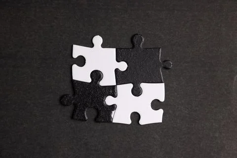 Opposite day concept using white and black puzzle pieces. Stock Photos
