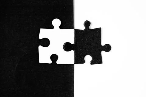 Opposite day concept using white and black puzzle pieces with oposite background Stock Photos