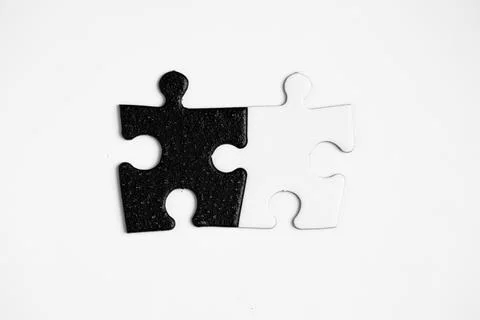 Opposite day concept using white and black puzzle pieces. Stock Photos