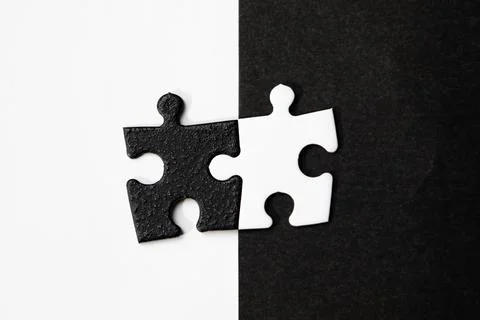 Opposite day concept using white and black puzzle pieces with oposite background Stock Photos