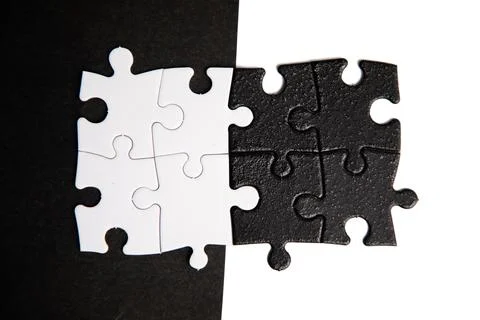 Opposite day concept using white and black puzzle pieces with oposite background Stock Photos