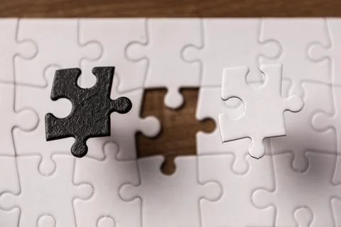 Opposite day concept using white and black puzzle pieces. Stock Photos