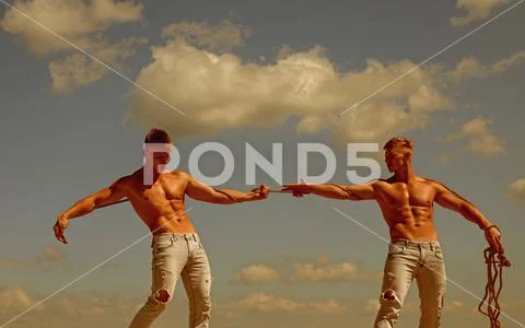 Opposites in sport. Men shows off their strength against competitors. Athletic Stock Photos