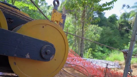 Optic fiber cable installation machine pulling wires in the jungle Stock Footage 341561810