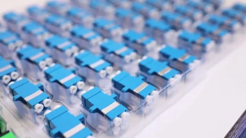 Optical adapters with different connectors in plastic blisters on the table Stock Footage 282983827