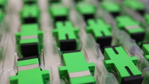 Optical adapters with different connectors in plastic blisters on the table Stock Footage 282983830