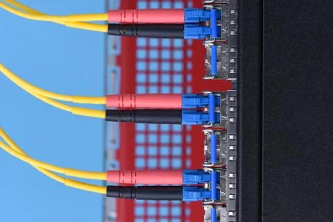 Optical cables connected to switch in data center Stock Photos