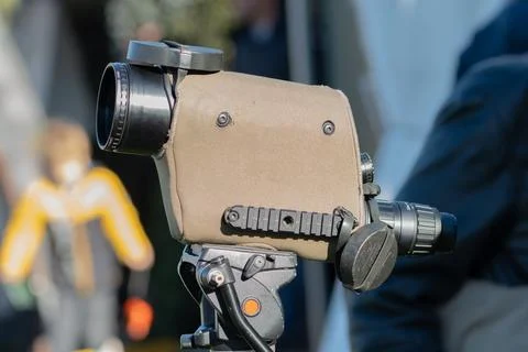 The optical device is mounted on a tripod and pointed forward for observation 스톡 사진