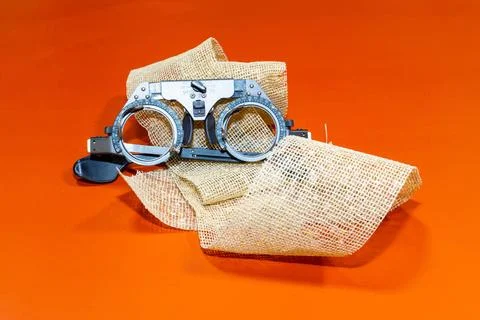 Optical device for vision testing on a brown cloth with a orange surface o... Stock Photos