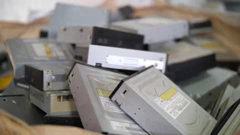 Optical disc drives falling down on stack in container. Waste management Stock Footage 105644657