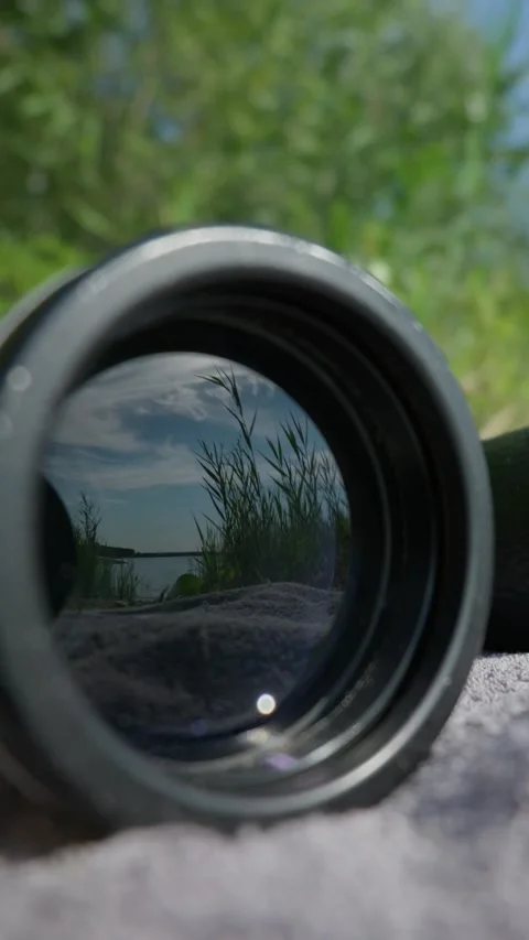 Optical Element Reflecting Lake Landscape in Grassy Field Close-Up 스톡 동영상 345174156