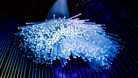 Optical fibres dinamic flying from deep on technology background Stock Photos