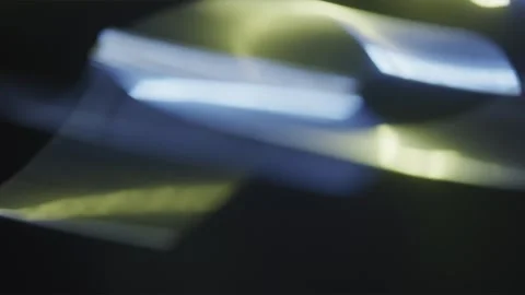 Optical Flash Of Blue and yellow Color On A Black Background Stock Footage 252751456