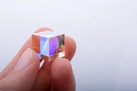 Optical glass cube in hand  Light dispersion,spectrum. Physics optics ray ref Stock Photos