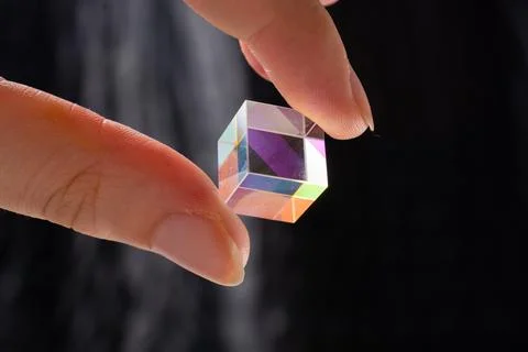 Optical glass cube in hand  Light dispersion,spectrum. Physics optics ray ref Stock Photos