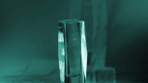 Optical Glow: Rotating Glass with Engraved Lighthouse in Vibrant Light Stock Footage 302945009