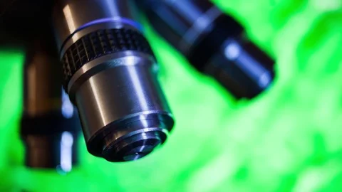 Optical Microscope on green background Stock Footage 77539613