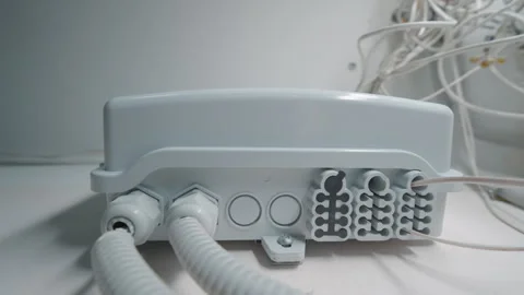 Optical Network Distribution Box Mounted on Wall with Cable Conduits and Wire Stock Footage 333433194