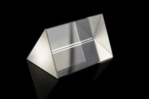 Optical prism for experiments isolated on the black background Stock Photos