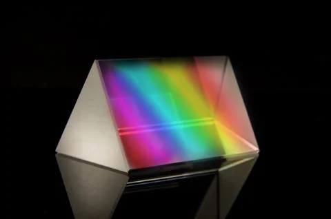 Optical prism for experiments isolated on the black background Stockfoto's