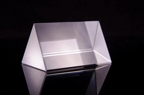 Optical prism for experiments isolated on the black background Stock Photos