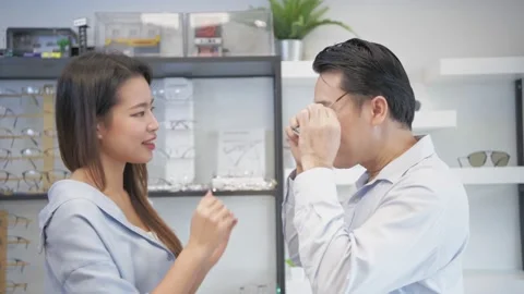 Optical shop concept of 4k Resolution. Asian couple testing glasses in a shop Stock Footage 146549057
