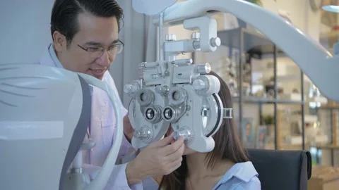 Optical shop concept of 4k Resolution. The ophthalmologist is examining the p Stock Footage 146549081