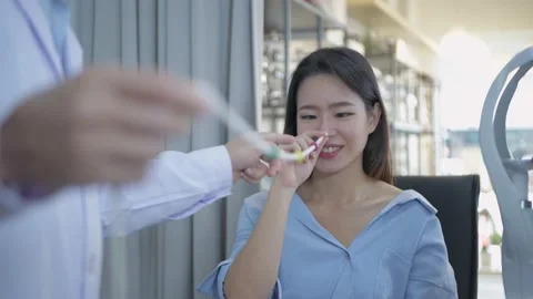 Optical shop concept of 4k Resolution. Young women measuring eyesight with st Stock Footage 146549129