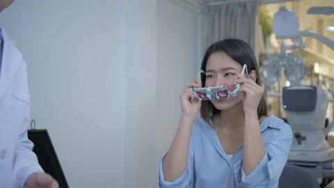 Optical shop concept of 4k Resolution. The ophthalmologist is measuring the c Stock Footage 147223611