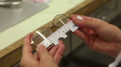 Optician checking measurements with professional ruler in glasses Stock Footage 60811925