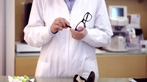 Optician doing maintenance on a  pair of glasses Video stock 56570382