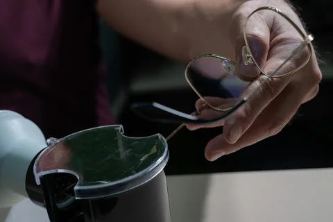 The optician fixes the frames of the glasses. Stock Photos
