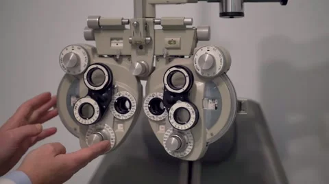 Optician setting a phoropter before a eyesight visit Stock Footage 56679751