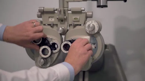 Optician setting a  phoropter in his studio Stock Footage 56575687