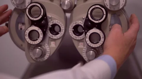 Optician setting a  phoropter in his studio Stock Footage 56575836
