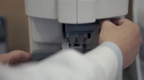 Optician testing lenses with a professional optical equipment Stock Footage 56570449